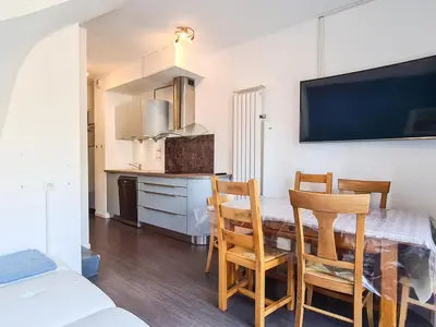 a kitchen and dining room with a table and chairs at Appartement lumineux au pied des pistes avec piscine et spa - FR-1-425-133 in Flaine