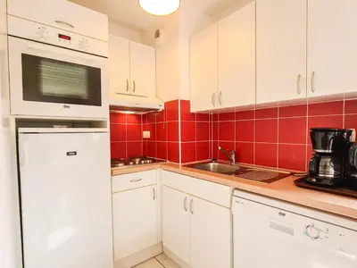 a kitchen with white cabinets and red tiles at Appartement lumineux 8 pers · Balcon · Parking en option - FR-1-425-131 in Flaine