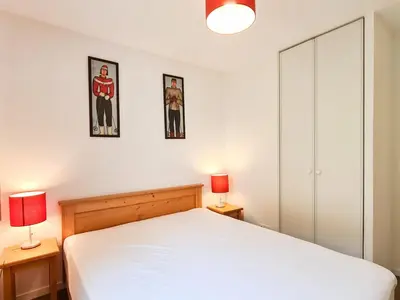 a bedroom with a white bed and two lamps at Appartement lumineux 8 pers · Balcon · Parking en option - FR-1-425-131 in Flaine