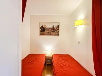 a small room with two beds and a picture on the wall at Appartement 6 pers. confortable à Flaine avec balcon - FR-1-425-148 in Flaine
