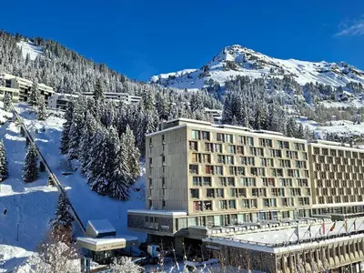 a hotel in the snow in front of a mountain at Appartement Confortable, Proche Pistes & Commerces, Balcon - FR-1-425-144 in Flaine