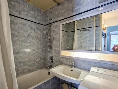 a bathroom with a sink and a tub and a mirror at Appartement Confortable, Proche Pistes & Commerces, Balcon - FR-1-425-144 in Flaine