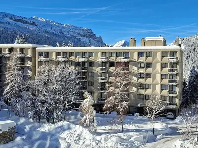 a large building in the snow with trees in front at Appartement Confortable, Proche Pistes & Commerces, Balcon - FR-1-425-144 in Flaine