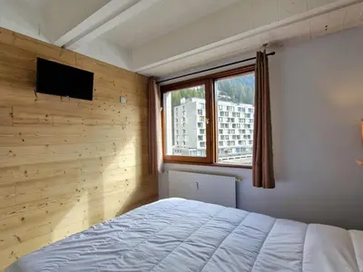 a bedroom with a bed and a window at Appartement Confortable, Proche Pistes & Commerces, Balcon - FR-1-425-144 in Flaine
