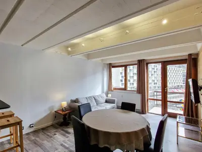 a living room with a table and a couch at Appartement Confortable, Proche Pistes & Commerces, Balcon - FR-1-425-144 in Flaine