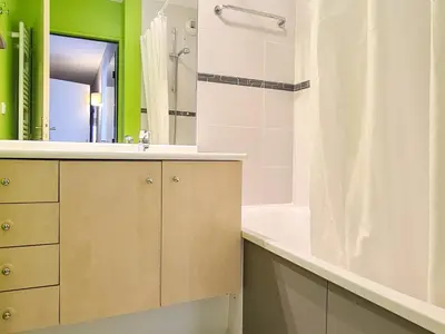 a bathroom with a sink and a tub and a mirror at Appartement spacieux et lumineux · 8 personnes · Balcon · Flaine Centre - FR-1-425-134 in Flaine