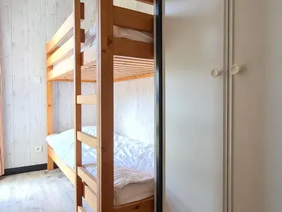 a bunk bed room with a ladder and a bunk bed at Appartement spacieux et lumineux · 8 personnes · Balcon · Flaine Centre - FR-1-425-134 in Flaine