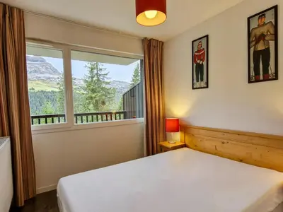 a bedroom with a bed and a large window at Appartement lumineux avec balcon au centre station - FR-1-425-141 in Flaine