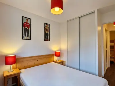 a bedroom with a white bed and two lamps at Appartement lumineux avec balcon au centre station - FR-1-425-141 in Flaine