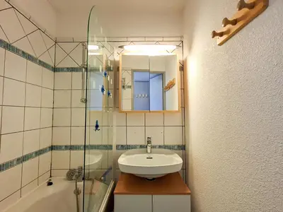 a bathroom with a sink and a glass shower at Studio rénové au centre de Flaine avec balcon pour 5 personnes - FR-1-425-154 in Flaine