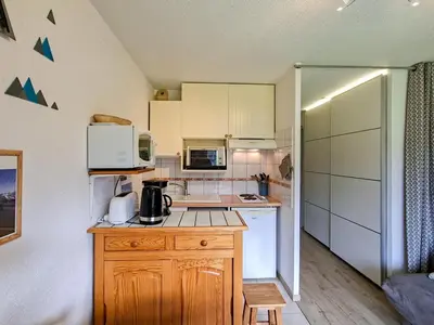 a kitchen with white cabinets and a counter top at Studio rénové au centre de Flaine avec balcon pour 5 personnes - FR-1-425-154 in Flaine