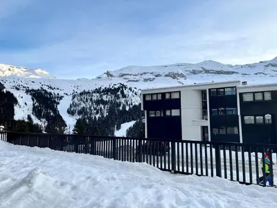 a building on top of a snow covered mountain at Appartement confortable au pied des pistes avec piscine et parking - FR-1-425-138 in Flaine