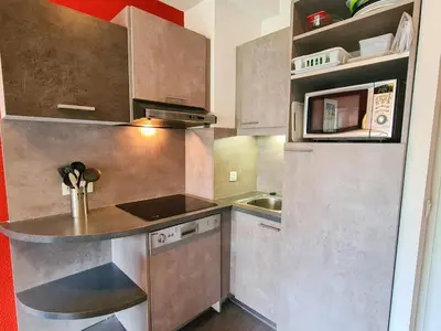 a small kitchen with a sink and a microwave at Appartement confortable au pied des pistes avec piscine et parking - FR-1-425-138 in Flaine