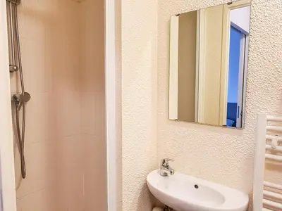 a bathroom with a sink and a mirror and a shower at Appartement confortable au pied des pistes avec piscine et parking - FR-1-425-138 in Flaine