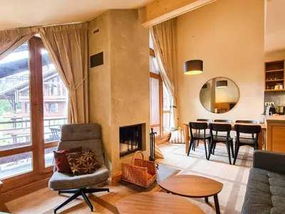 a living room with a fireplace and a table at Appartement confortable 3 pièces à Flaine - 6 pers - FR-1-425-140 in Flaine