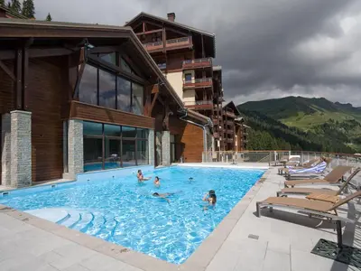 a group of people in a swimming pool next to a building at Appartement confortable 3 pièces à Flaine - 6 pers - FR-1-425-140 in Flaine