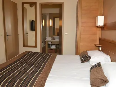 a hotel room with a bed and a bathroom at Appartement confortable 3 pièces à Flaine - 6 pers - FR-1-425-140 in Flaine