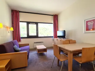 a living room with a table and a couch at Appartement confortable proche des pistes avec casier à ski - FR-1-425-153 in Flaine