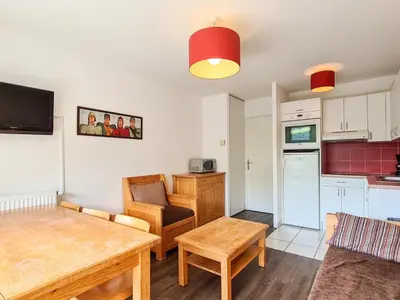a living room with a table and a kitchen at Appartement lumineux 6 pers à Flaine avec balcon et options parking - FR-1-425-149 in Flaine
