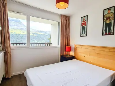 a bedroom with a white bed and a window at Appartement lumineux 6 pers à Flaine avec balcon et options parking - FR-1-425-149 in Flaine