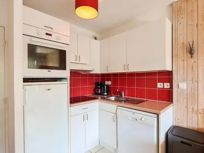 a kitchen with white cabinets and red tiles at Appartement lumineux 6 pers à Flaine avec balcon et options parking - FR-1-425-149 in Flaine