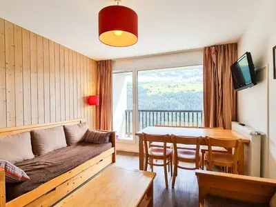 a living room with a couch and a table at Appartement lumineux 6 pers à Flaine avec balcon et options parking - FR-1-425-149 in Flaine