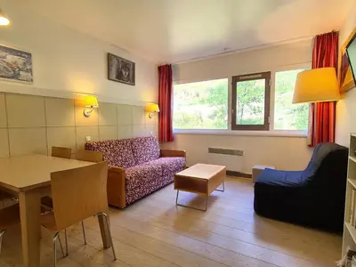 a living room with a couch and a table at Appartement Confortable 2 Pièces, Proche des Pistes, WIFI Gratuit - FR-1-425-165 in Flaine