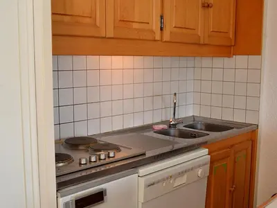 a kitchen with a stove and a sink at Studio rénové 4 pers, proche pistes, balcon, casier ski - FR-1-425-172 in Flaine
