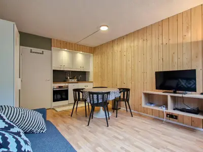 a room with a kitchen and a table with chairs at Studio confortable proche des pistes, idéal pour 4 personnes - FR-1-425-182 in Flaine