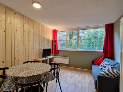 a living room with a table and a couch at Studio confortable proche des pistes, idéal pour 4 personnes - FR-1-425-182 in Flaine