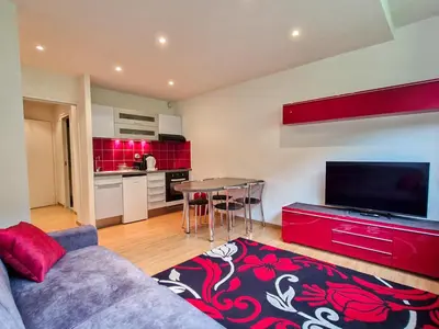 a living room with a couch and a table and a kitchen at Studio rénové pour 4 pers, proche des pistes à Flaine - FR-1-425-167 in Flaine