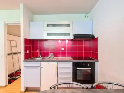 a kitchen with a sink and a red tile wall at Studio rénové pour 4 pers, proche des pistes à Flaine - FR-1-425-167 in Flaine