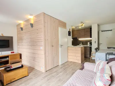 a living room with a large wooden wall at Studio neuf pour 4 pers. au centre de Flaine avec balcon - FR-1-425-170 in Flaine