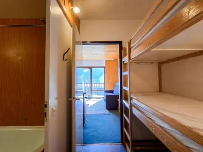 a room with two bunk beds and a bathroom at Studio confortable à Flaine, balcon et proximité pistes - FR-1-425-180 in Flaine