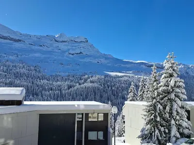 a building with a snow covered mountain in the background at Studio confortable à Flaine, balcon et proximité pistes - FR-1-425-180 in Flaine