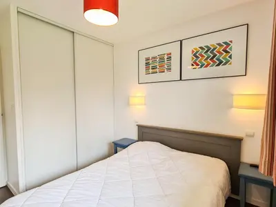 a small bedroom with a bed and two tables at Appartement Confortable 4 Pers. Flaine Centre, Balcon Sud - FR-1-425-161 in Flaine