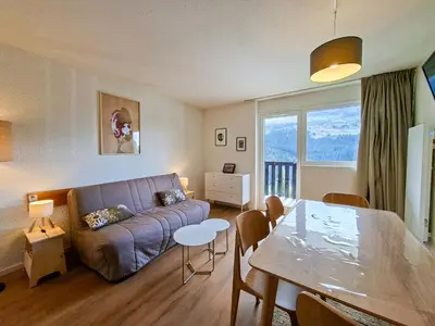 a living room with a couch and a table at Studio rénové 4 pers · Centre Flaine · Balcon Sud - FR-1-425-176 in Flaine