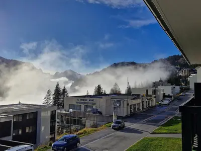 a city with cars parked on a street with mountains at Studio rénové 4 pers · Centre Flaine · Balcon Sud - FR-1-425-176 in Flaine