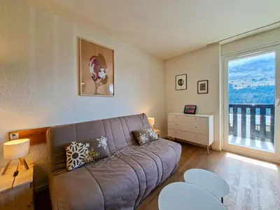 a living room with a couch and a large window at Studio rénové 4 pers · Centre Flaine · Balcon Sud - FR-1-425-176 in Flaine