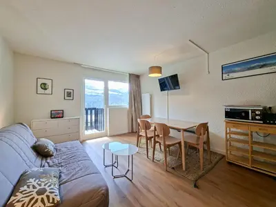 a living room with a couch and a table at Studio rénové 4 pers · Centre Flaine · Balcon Sud - FR-1-425-176 in Flaine