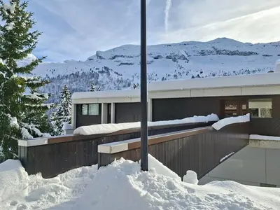 a house in the snow with snow piled around it at Studio rénové avec balcon proche des pistes, casier à ski - FR-1-425-156 in Flaine