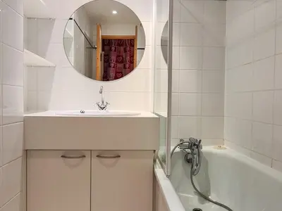 a bathroom with a sink and a tub and a mirror at Studio rénové avec balcon proche des pistes, casier à ski - FR-1-425-156 in Flaine