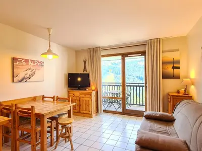 a living room with a dining room table and a television at Studio rénové avec balcon proche des pistes, casier à ski - FR-1-425-156 in Flaine