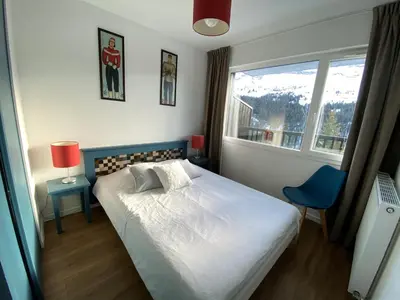 a bedroom with a large bed and a window at Appartement rénové, Balcon sud, Animaux admis, Parking en option - FR-1-425-155 in Flaine