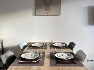 a table with chairs and plates and wine glasses at Appartement rénové, Balcon sud, Animaux admis, Parking en option - FR-1-425-155 in Flaine