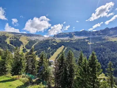 a view of a valley with trees and mountains at Appartement lumineux au centre de Flaine avec balcon - FR-1-425-184 in Flaine