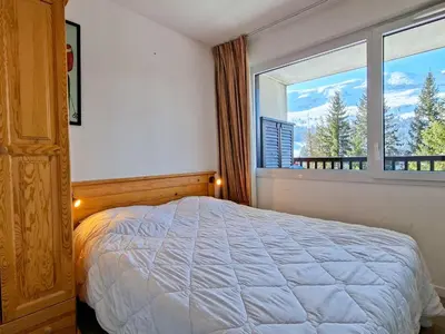 a bedroom with a bed and a large window at Appartement lumineux au centre avec balcon et parking - FR-1-425-177 in Flaine