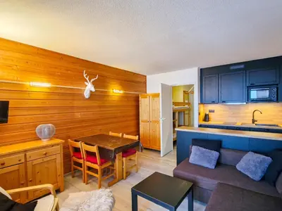 a living room with a table and a kitchen at Studio lumineux avec balcon - Flaine - FR-1-425-160 in Flaine