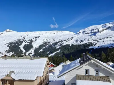 a snow covered mountain with a house in the foreground at Studio lumineux avec balcon - Flaine - FR-1-425-160 in Flaine