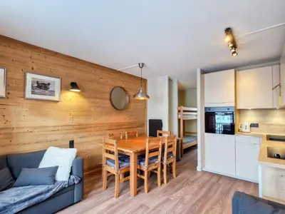 a kitchen and living room with a table and a couch at Appartement Sud Confort 4-5 pers, Balcon, Proche pistes - FR-1-425-173 in Flaine